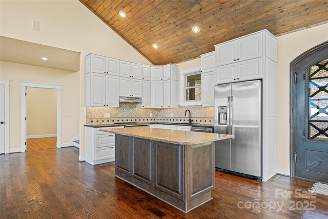 179 Serenity Ridge Trl, Asheville, NC 28804 - kitchen with stainless steel fridge, a sink, under cabinet range hood, wooden ceiling, and white cabinetry