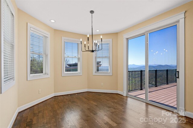 179 Serenity Ridge Trl, Asheville, NC 28804 - unfurnished dining area featuring baseboards, a chandelier, wood finished floors, a mountain view, and recessed lighting
