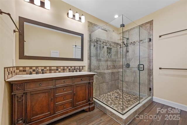 179 Serenity Ridge Trl, Asheville, NC 28804 - full bathroom featuring a stall shower, wood finished floors, decorative backsplash, vanity, and recessed lighting