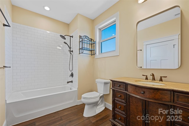 179 Serenity Ridge Trl, Asheville, NC 28804 - bathroom featuring wood finished floors, toilet, vanity, washtub / shower combination, and baseboards