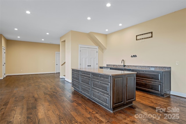 179 Serenity Ridge Trl, Asheville, NC 28804 - kitchen with dark wood-style flooring, baseboards, a center island, a sink, and recessed lighting