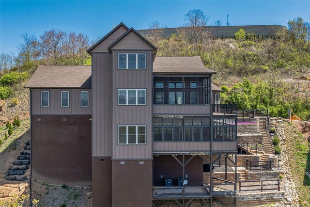 179 Serenity Ridge Trl, Asheville, NC 28804 - rear view of house with stairway, a sunroom, and a shingled roof