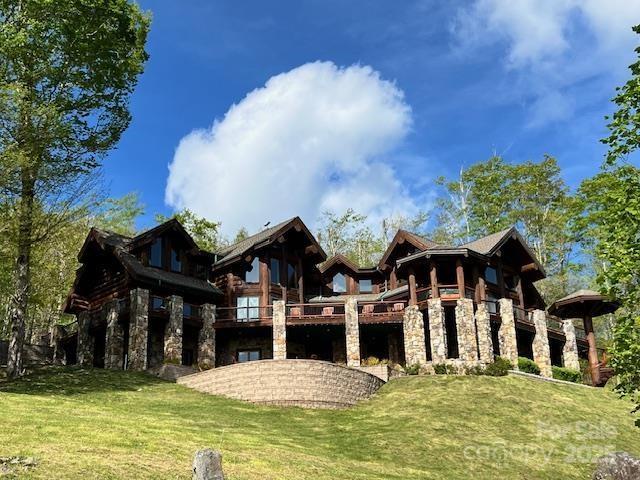 51 Airport Rd, Mars Hill, NC 28754 - back of property with stone siding, a lawn, and a balcony