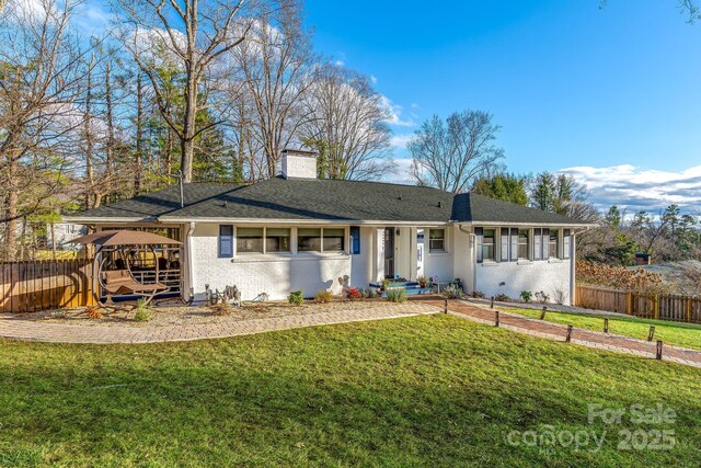 2 Bevlyn Dr, Asheville, NC 28803 - view of front of property featuring fence, a chimney, brick siding, and a front yard