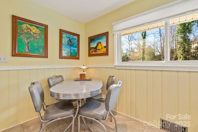 2 Bevlyn Dr, Asheville, NC 28803 - tiled dining area with visible vents and a wainscoted wall