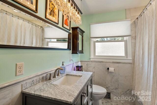 2 Bevlyn Dr, Asheville, NC 28803 - full bath with tile walls, toilet, and plenty of natural light