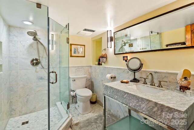 2 Bevlyn Dr, Asheville, NC 28803 - full bathroom with toilet, tile walls, a stall shower, visible vents, and vanity