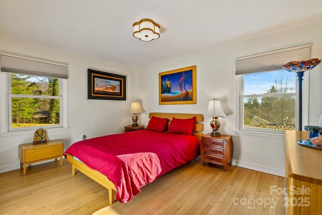 2 Bevlyn Dr, Asheville, NC 28803 - bedroom featuring hardwood / wood-style floors, baseboards, and multiple windows