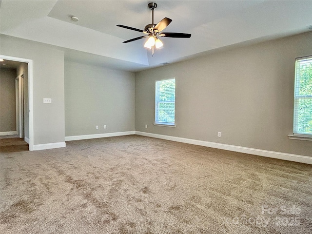 unfurnished room featuring visible vents, baseboards, ceiling fan, and carpet floors