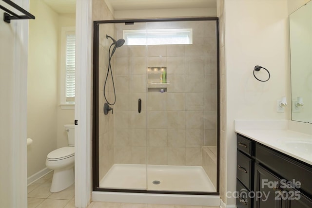 full bathroom featuring toilet, a stall shower, tile patterned flooring, and vanity