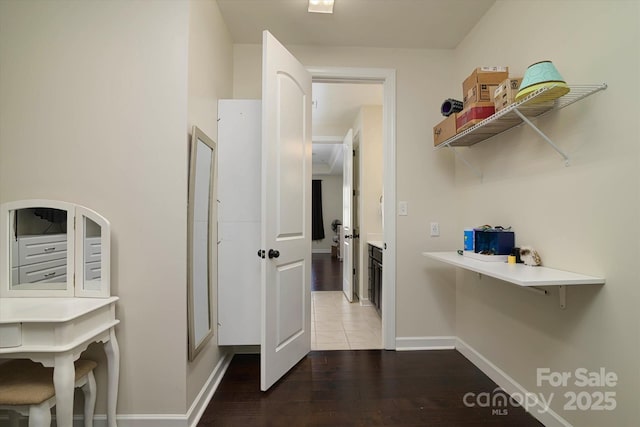 interior space featuring baseboards and wood finished floors