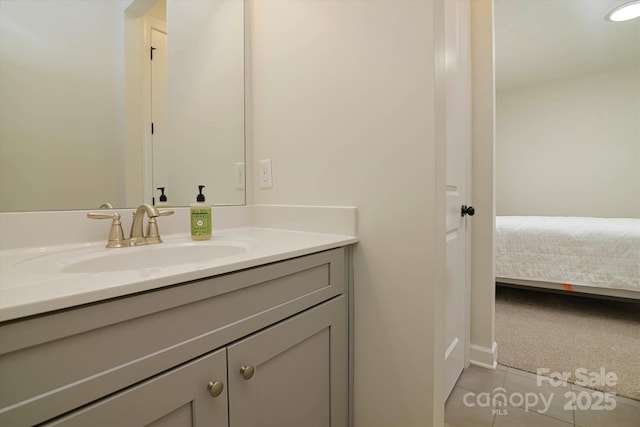 ensuite bathroom with ensuite bathroom, tile patterned floors, and vanity