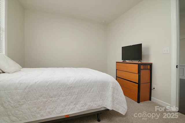 carpeted bedroom featuring baseboards