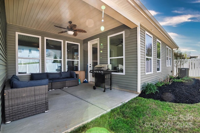 view of patio / terrace featuring fence, grilling area, a ceiling fan, an outdoor living space, and cooling unit