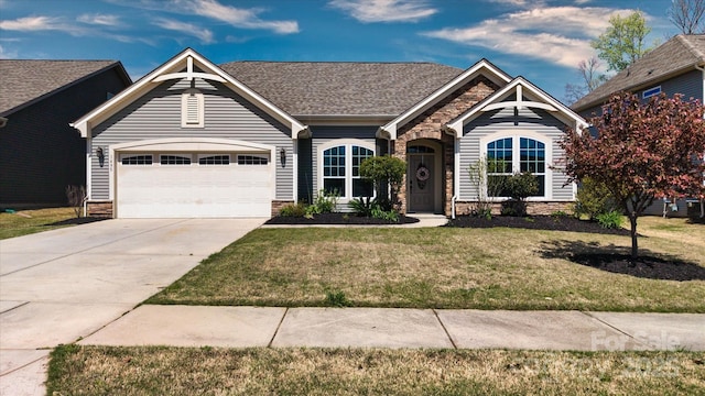 view of front of property with stone siding, driveway, a garage, and a front yard
