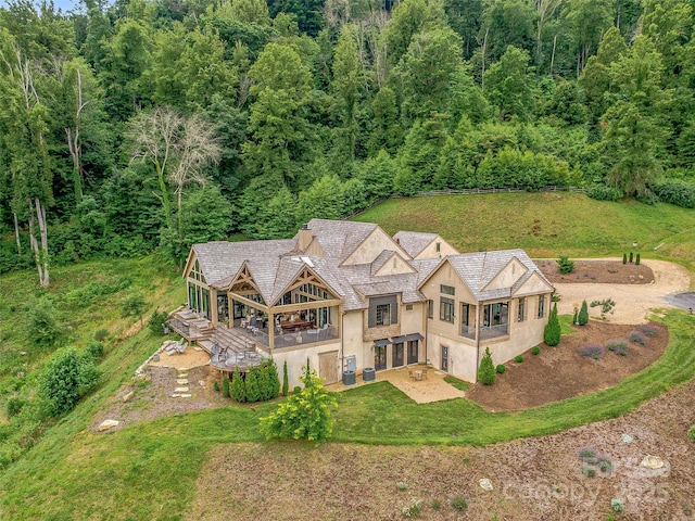 birds eye view of property with a wooded view