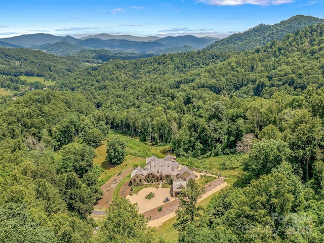 drone / aerial view featuring a view of trees and a mountain view