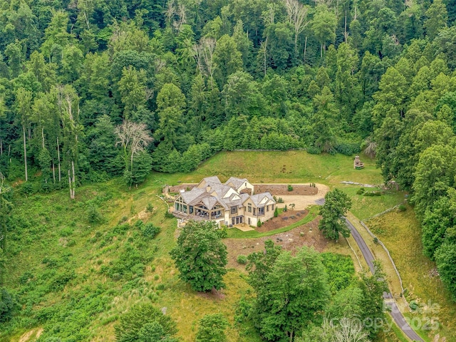 drone / aerial view featuring a view of trees
