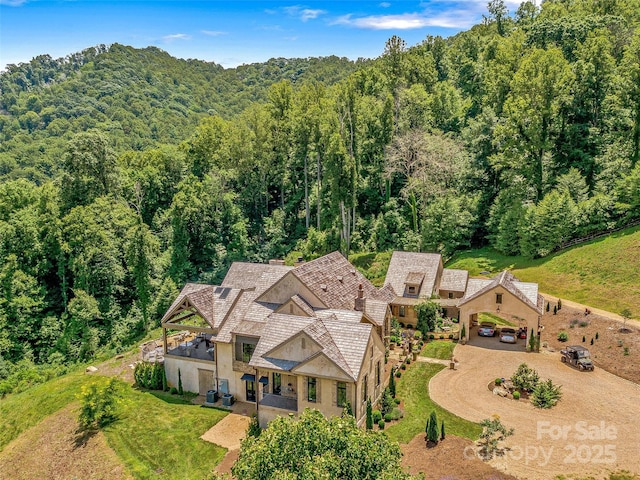 aerial view featuring a wooded view
