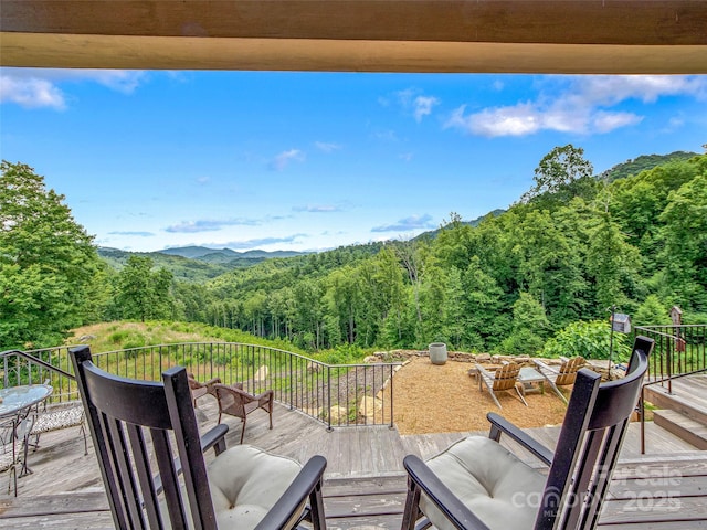 wooden deck with a forest view