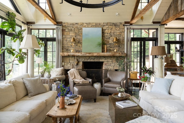 living room featuring a healthy amount of sunlight, lofted ceiling with beams, and a fireplace