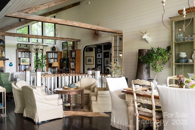 living area with wooden walls, high vaulted ceiling, wood-type flooring, and beam ceiling
