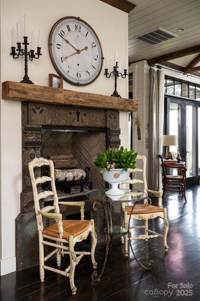 interior space featuring visible vents, wooden ceiling, wood finished floors, and a fireplace