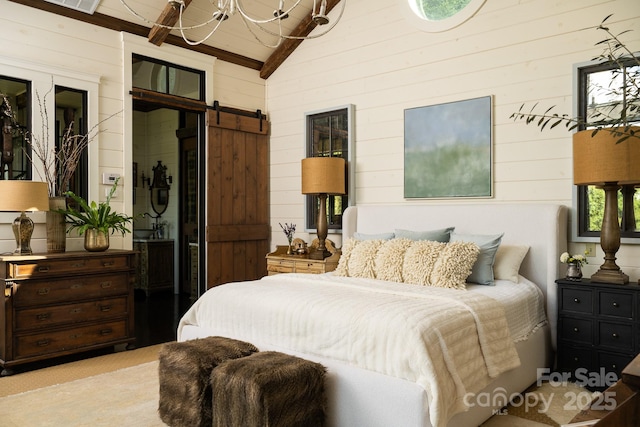 bedroom featuring wooden walls, vaulted ceiling with beams, an inviting chandelier, and a barn door