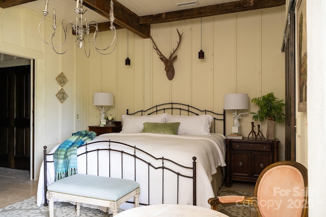 bedroom featuring visible vents, a decorative wall, and vaulted ceiling with beams