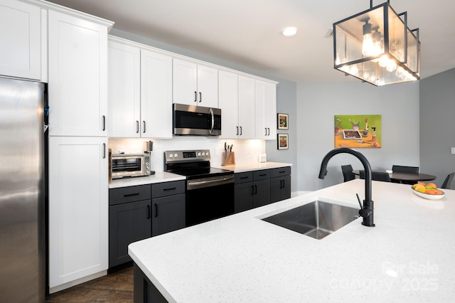 55 S Market St Unit 101, Asheville, NC 28801 - kitchen with white cabinetry, appliances with stainless steel finishes, a sink, decorative backsplash, and a toaster