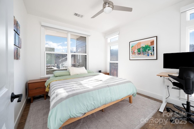 55 S Market St Unit 101, Asheville, NC 28801 - bedroom with visible vents, baseboards, multiple windows, and wood finished floors