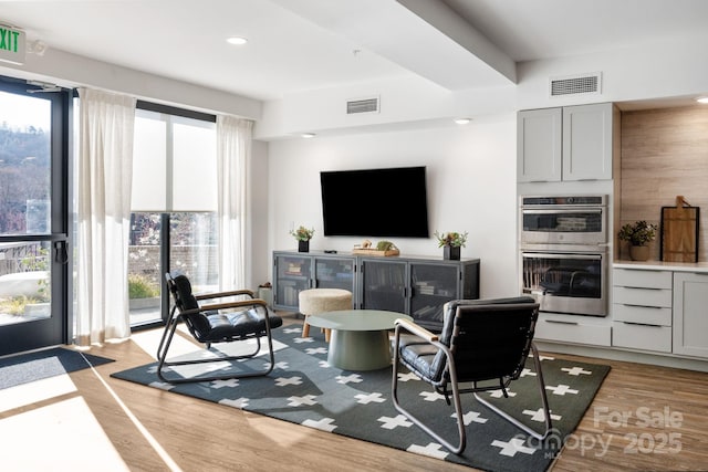 55 S Market St Unit 101, Asheville, NC 28801 - living area featuring light wood finished floors, beverage cooler, visible vents, and recessed lighting