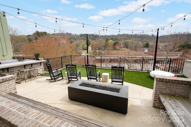 55 S Market St Unit 101, Asheville, NC 28801 - view of patio featuring a fenced backyard, a fire pit, and outdoor dry bar