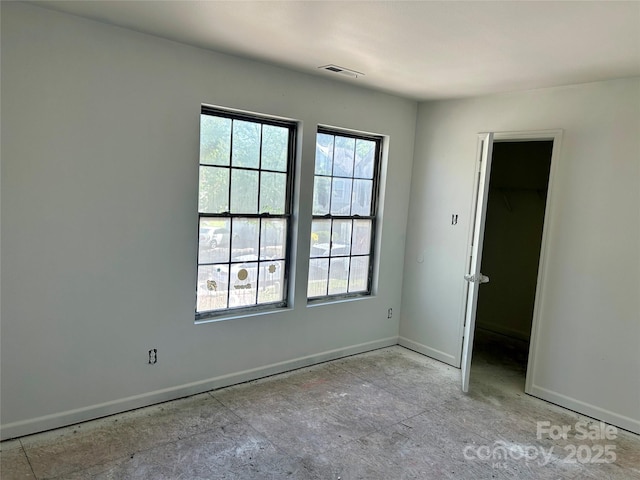 2752 Bramble Ridge Ct, Charlotte, NC 28215 - unfurnished bedroom with a spacious closet, visible vents, and baseboards