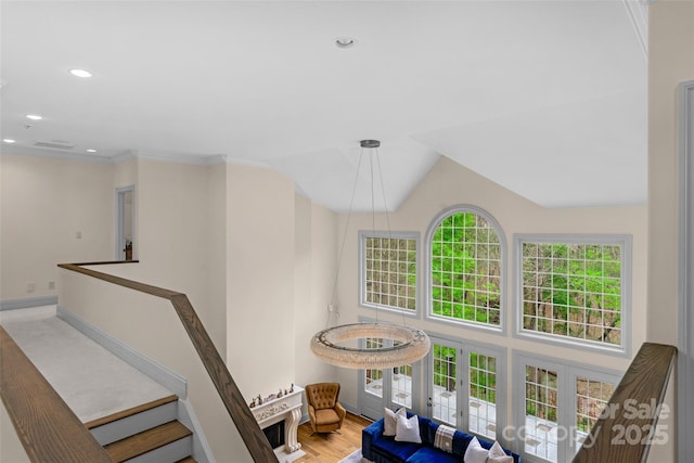 stairs with french doors, recessed lighting, high vaulted ceiling, and wood finished floors