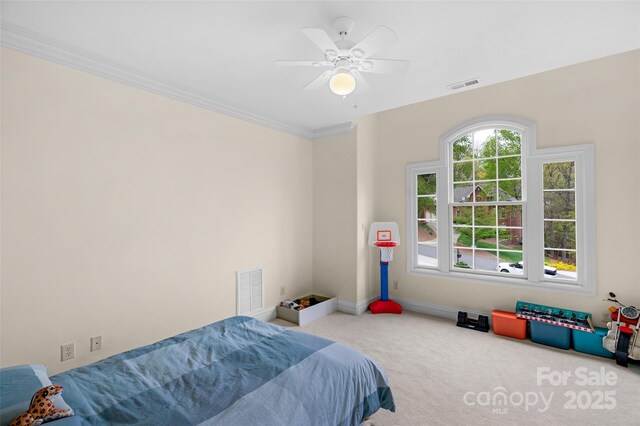 bedroom featuring carpet floors, ornamental molding, baseboards, and visible vents