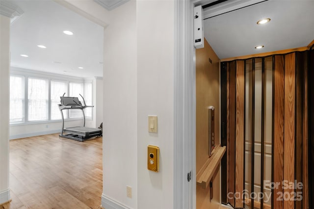 interior space featuring ornamental molding, baseboards, light wood finished floors, and recessed lighting