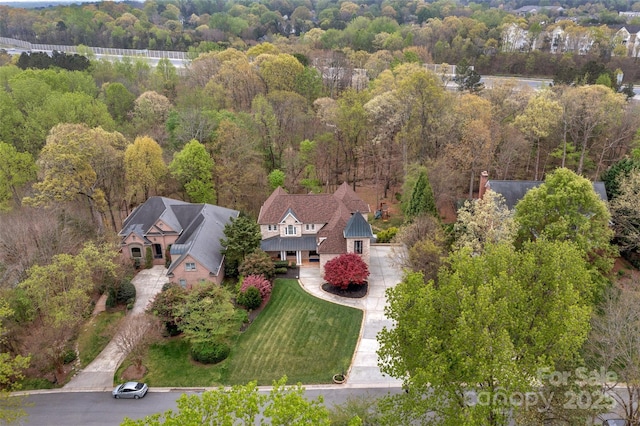birds eye view of property with a wooded view