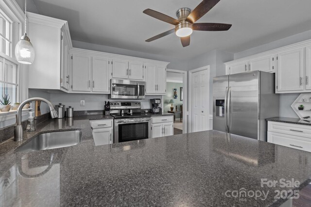 2439 Heathershire Ln, Matthews, NC 28105 - kitchen featuring stainless steel appliances, a sink, a ceiling fan, and white cabinets