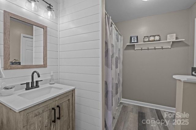 2439 Heathershire Ln, Matthews, NC 28105 - full bath featuring wood finished floors, vanity, baseboards, and a shower with curtain