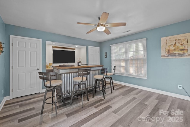 2439 Heathershire Ln, Matthews, NC 28105 - indoor dry bar with wood finished floors, ceiling fan, and baseboards