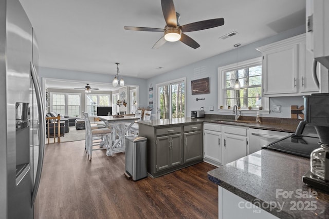 2439 Heathershire Ln, Matthews, NC 28105 - kitchen with stainless steel fridge with ice dispenser, a ceiling fan, a sink, a peninsula, and dark wood-type flooring