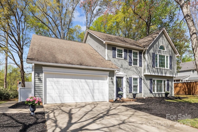 2439 Heathershire Ln, Matthews, NC 28105 - view of front of house featuring fence, driveway, a garage, and roof with shingles