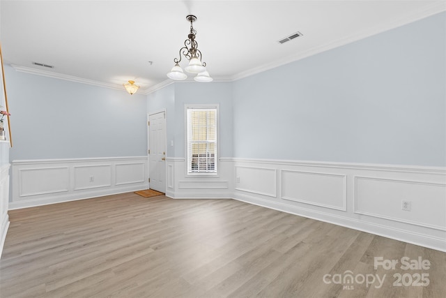 1386 21st Ave NE, Hickory, NC 28601 - unfurnished dining area with crown molding, wood finished floors, and wainscoting