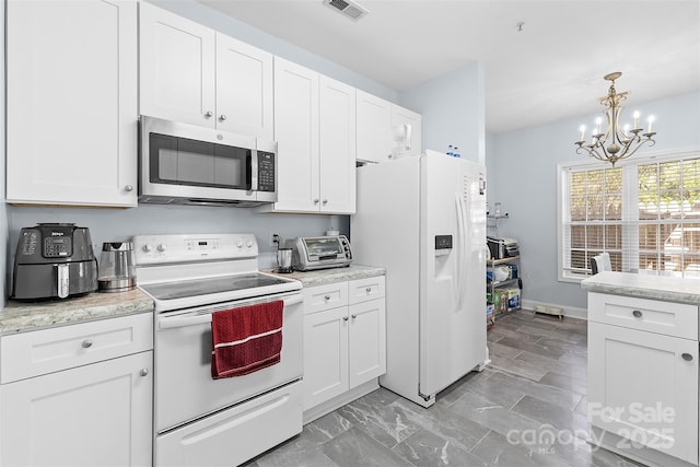 1386 21st Ave NE, Hickory, NC 28601 - kitchen featuring white appliances, white cabinetry, a chandelier, and light countertops