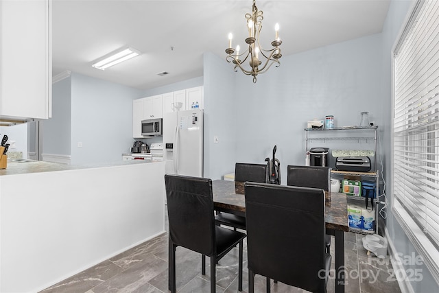 1386 21st Ave NE, Hickory, NC 28601 - dining area featuring marble look tile flooring and a chandelier