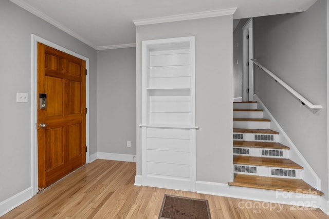 1801 Weststone Dr, Charlotte, NC 28208 - foyer entrance featuring crown molding, baseboards, stairway, and wood finished floors