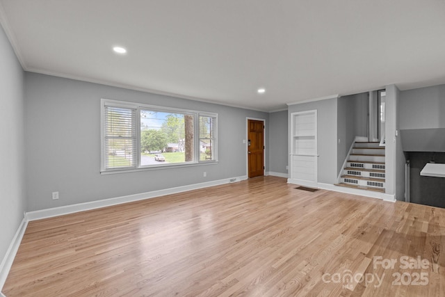 1801 Weststone Dr, Charlotte, NC 28208 - unfurnished living room with stairway, light wood-style floors, baseboards, and ornamental molding