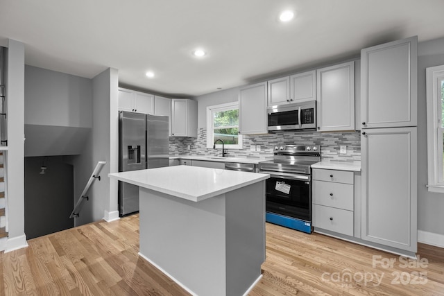 1801 Weststone Dr, Charlotte, NC 28208 - kitchen featuring stainless steel appliances, light wood-style floors, and light countertops
