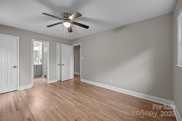 1801 Weststone Dr, Charlotte, NC 28208 - unfurnished bedroom with baseboards, light wood-type flooring, connected bathroom, and ceiling fan